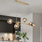 Taklampa i Guldtonad Metall med 6 Glaskupor – Elegant Belysning för Matbord & Vardagsrum – Lumière